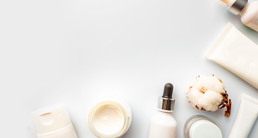 Top view of a variety of skincare products and a natural cotton plant on a clean, white background. Advancements in Regenerative Medicine Research and Education
