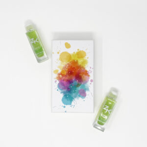ZK FACE serum bottles flanking a vibrant, color-splashed canvas on a white surface.