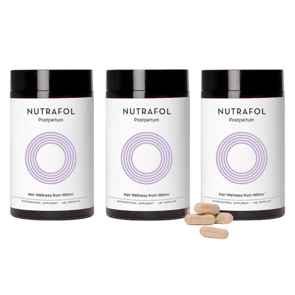 Three bottles of Nutrafol Postpartum hair wellness supplement with capsules displayed in front.
