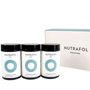 Three bottles of Nutrafol Men dietary supplements displayed in front of their box with the slogan "Keep growing.