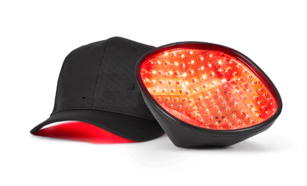 A HairSmart laser hair growth cap with red light therapy diodes illuminated inside, integrated into a black baseball cap with a red underside brim.